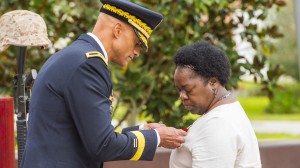 Brig. Gen. Espaillat presents the Gold Star pin to Wrenita Codrington.