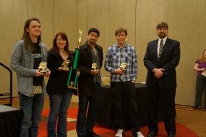 Members of Valencia's Brain Bowl Red Team -- from left, Lincoln Warner, Cassandra Logan, Diorcy Ortiz and Conan Wilson --  accept their trophy for winning second place at the national community college championships.