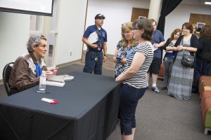 Temple Grandin (left) signs copies of her books.