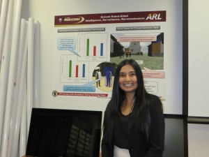 Dr. Crystal Maraj displays a poster with findings of her research on the use of simulators in Army training.