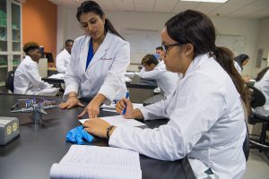 Professor Hemangi Patil explains lab procedure to a student.