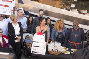 Al Roker and Sunny Anderson give culinary student Sasha Sincic a set of All-Clad pans. 